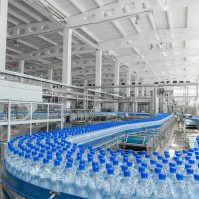 Tashkent Uzbekistan - June 7 2016: the manufacturing plant and bottling water in plastic bottles. Water bottles on conveyor belt