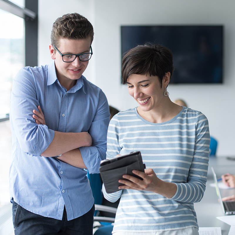 Two Business People Working With Tablet in office