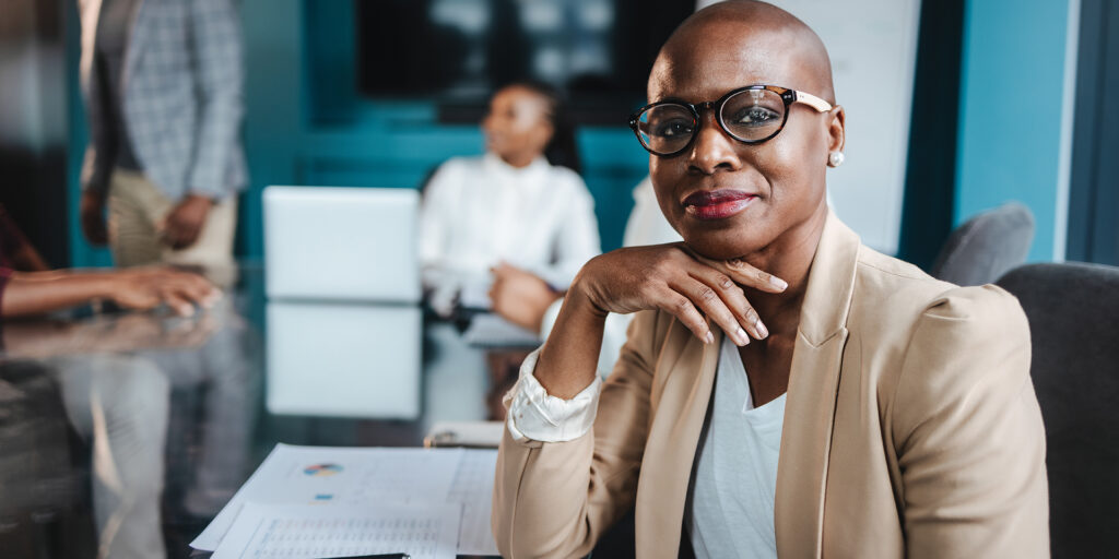 Successful black businesswoman in a corporate boardroom meeting with colleagues