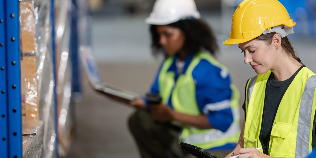 Warehouse worker team and manager checks stock and inventory wit