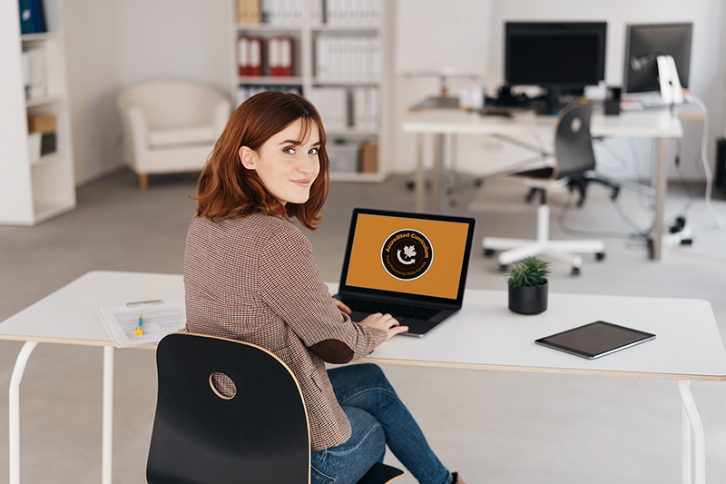 Friendly young businesswoman turning to camera